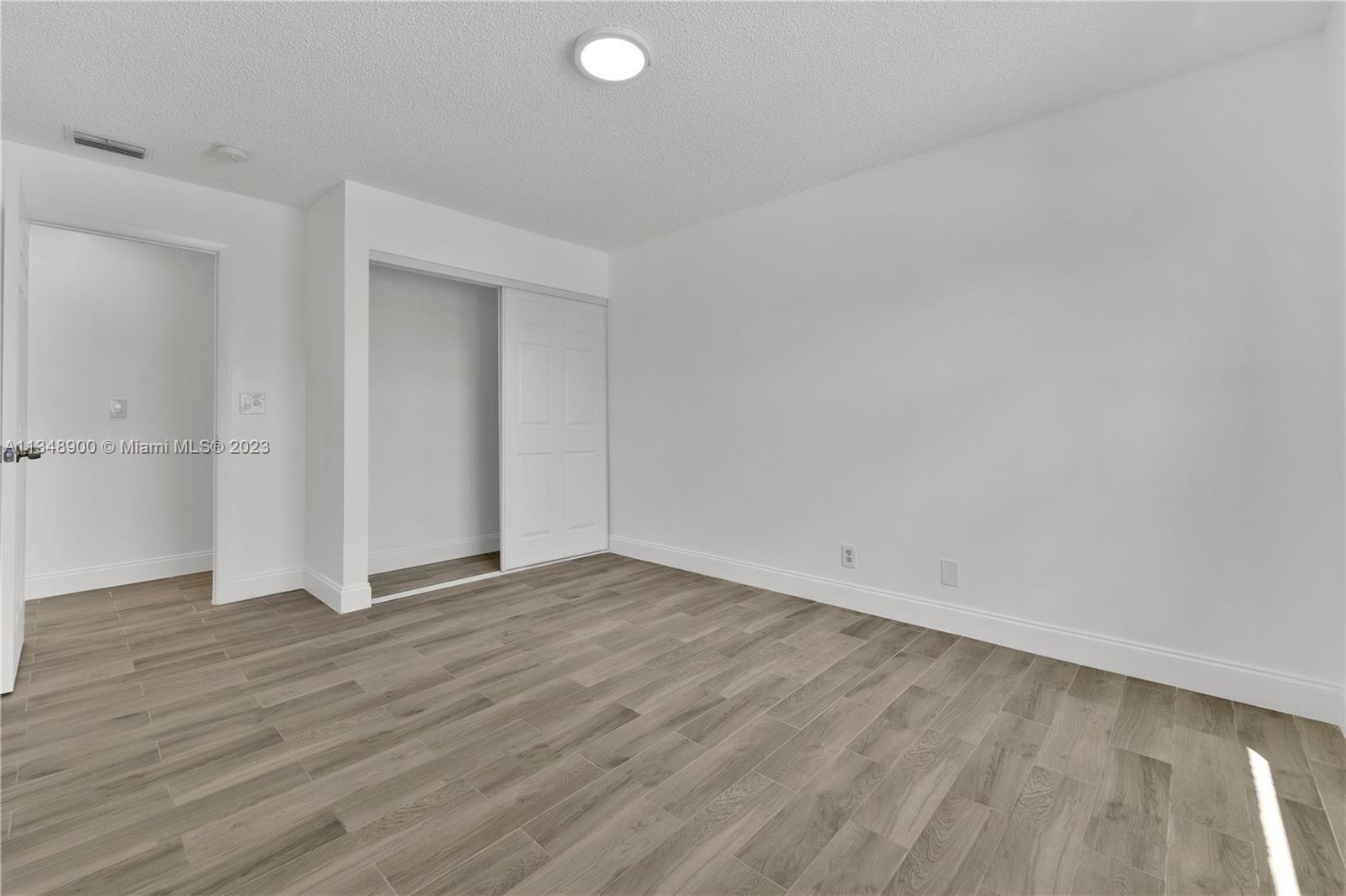 464 Springdale Circle, Unit 46D Palm Springs, FL 33461 - Photo 12 of 21 a view of an empty room and wooden floor
