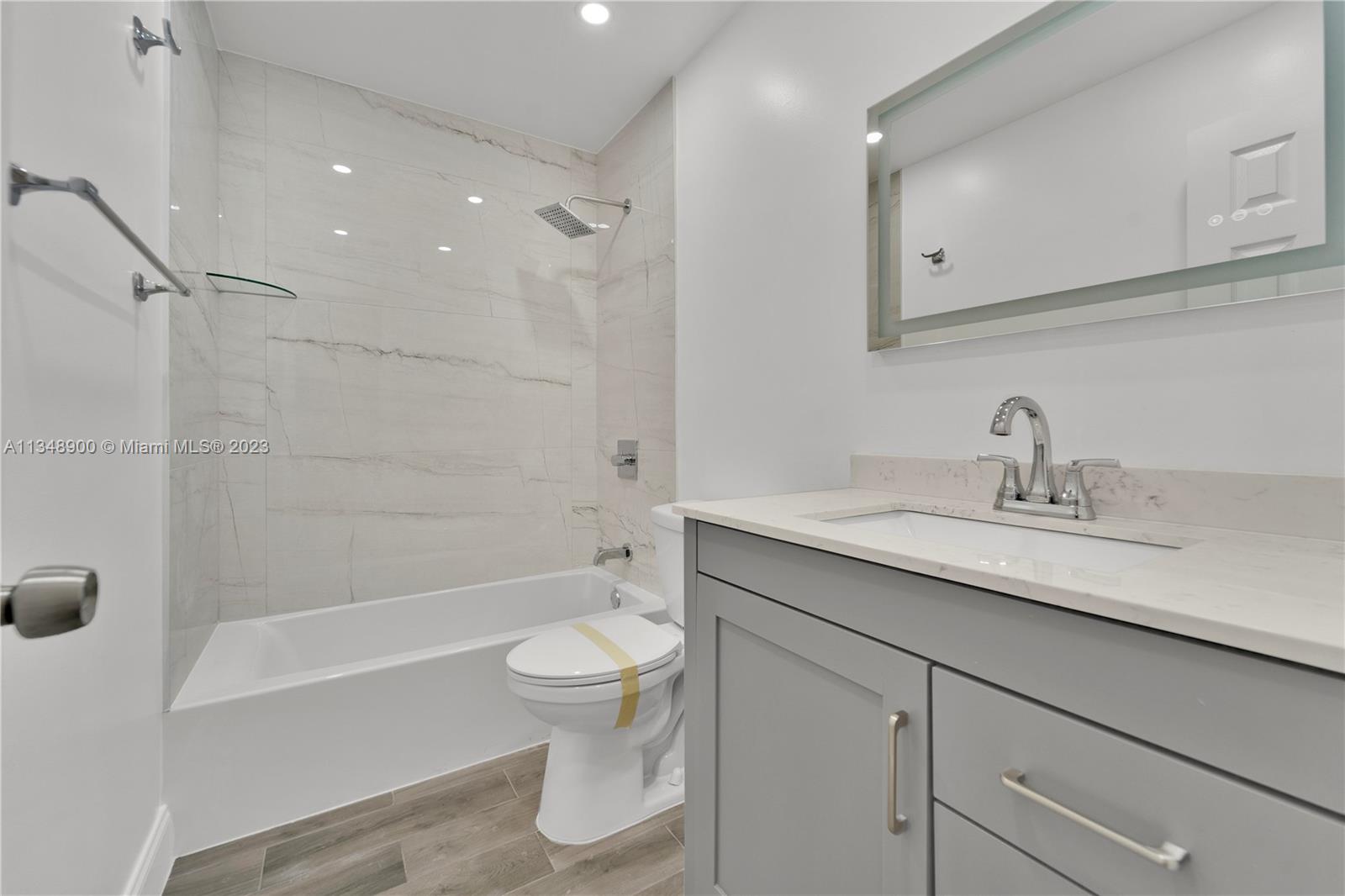 464 Springdale Circle, Unit 46D Palm Springs, FL 33461 - Photo 13 of 21 a bathroom with a sink a toilet and shower
