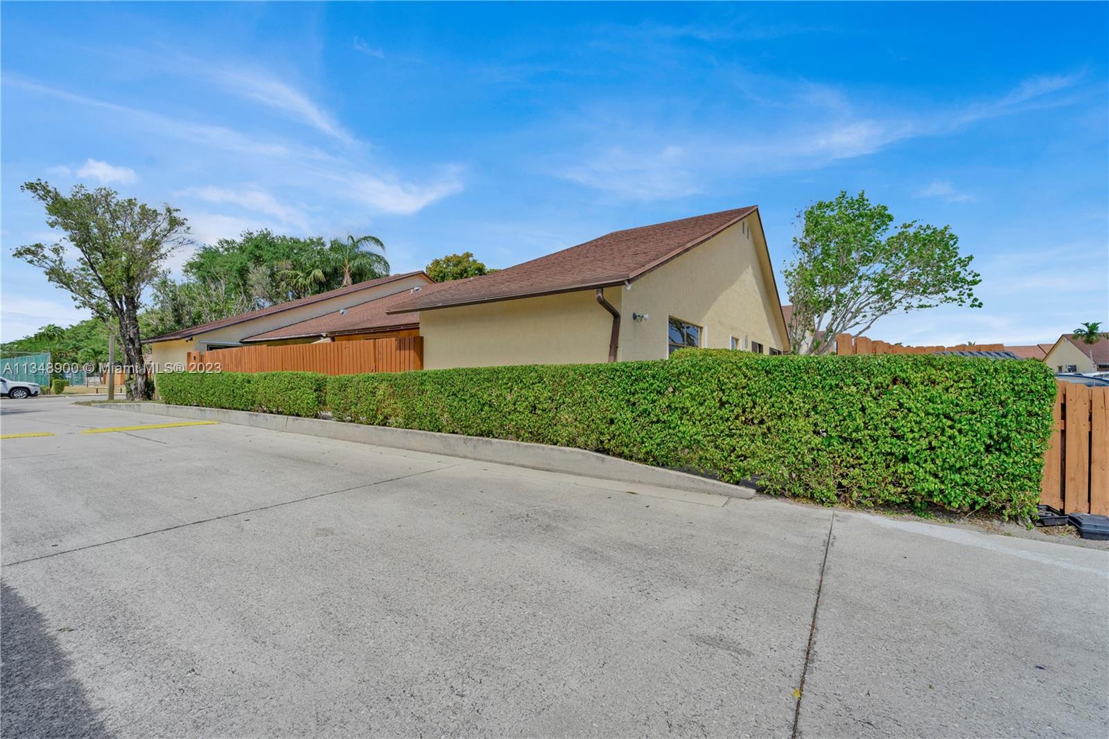 464 Springdale Circle, Unit 46D Palm Springs, FL 33461 - Photo 20 of 21 a backyard of a house with a yard and garage