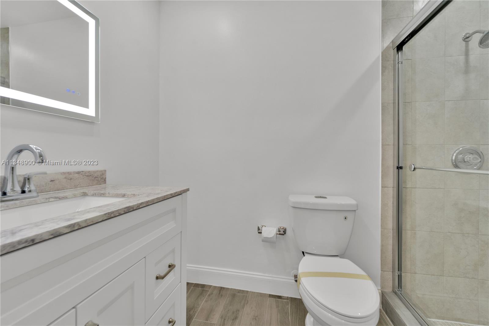 464 Springdale Circle, Unit 46D Palm Springs, FL 33461 - Photo 8 of 21 a white toilet sitting next to a bathroom sink