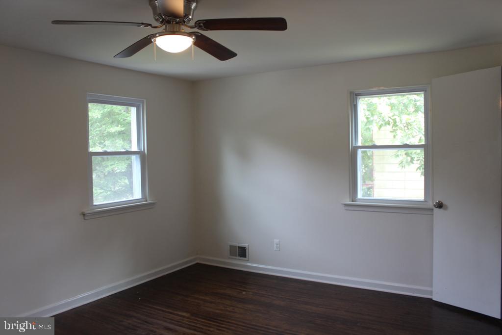 408 Villanova Road Glassboro, NJ 08028 - Photo 13 of 18 a view of an empty room with wooden floor and a window