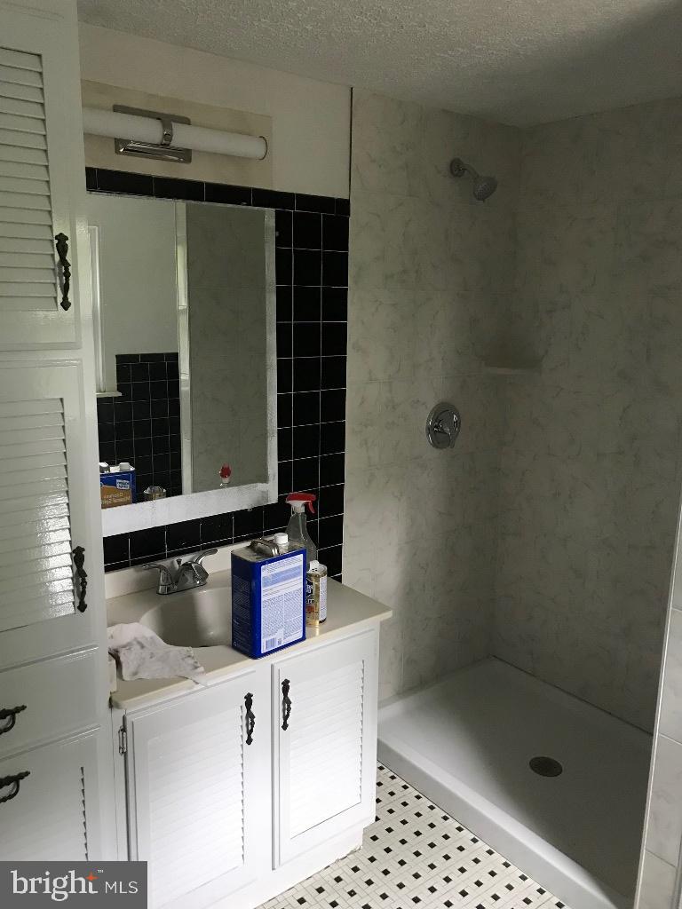 408 Villanova Road Glassboro, NJ 08028 - Photo 14 of 18 a bathroom with a shower and a sink