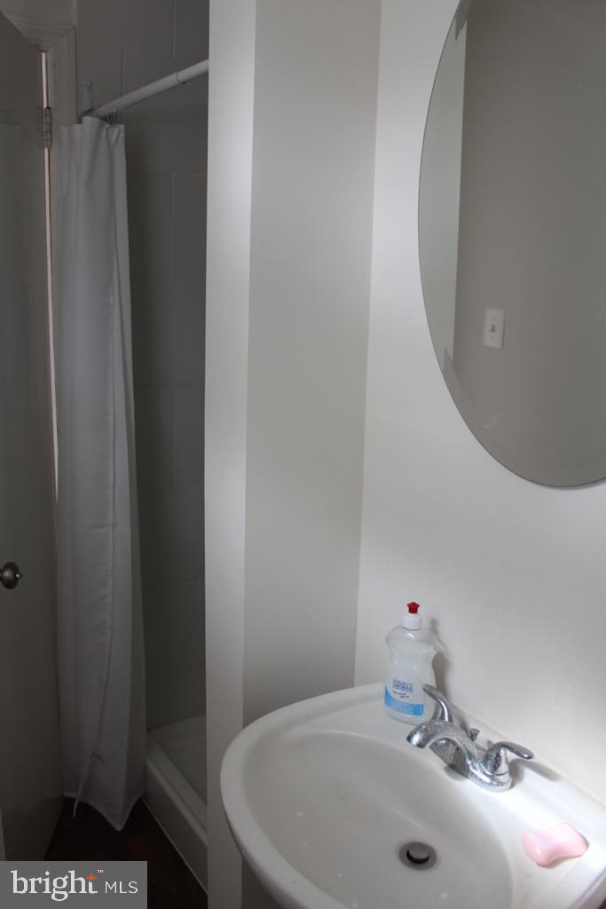 408 Villanova Road Glassboro, NJ 08028 - Photo 16 of 18 a bathroom with a sink and a mirror