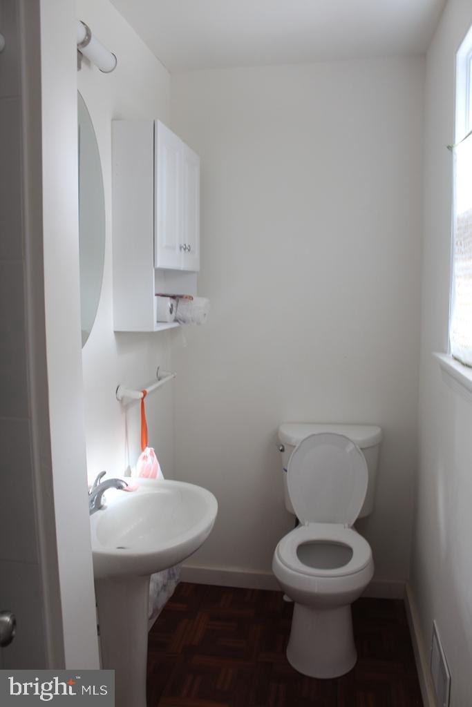 408 Villanova Road Glassboro, NJ 08028 - Photo 17 of 18 a bathroom with a toilet a sink and mirror