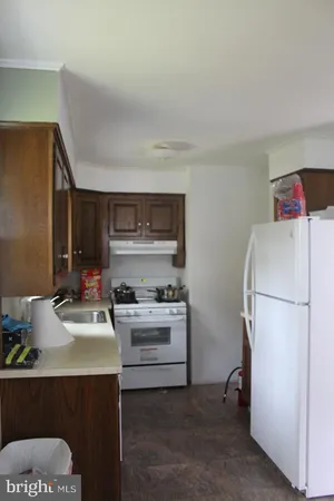 a kitchen with a sink appliances and cabinets
