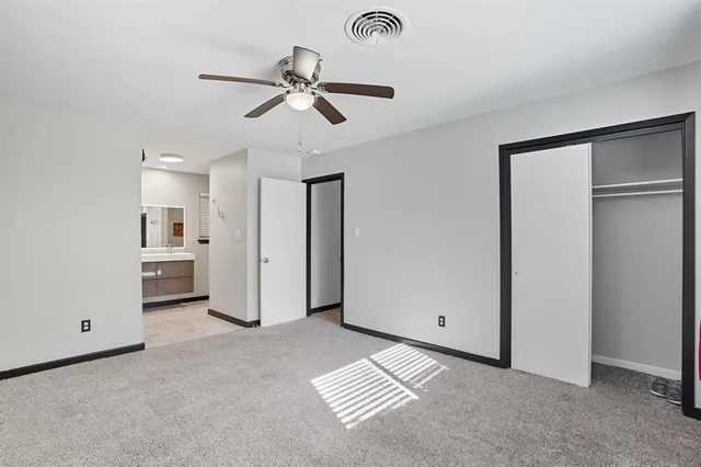 a view of a livingroom with a chandelier fan and entryway