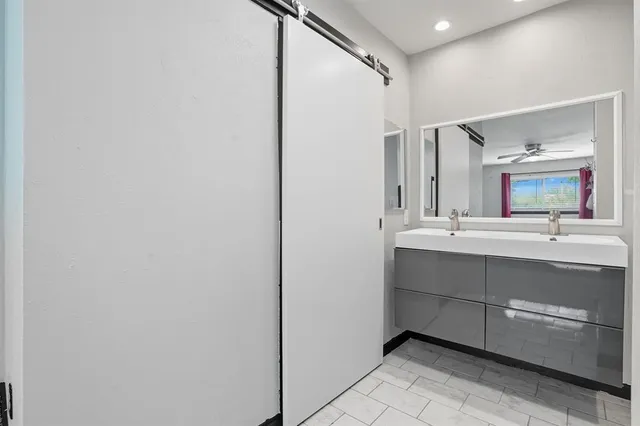a bathroom with a sink vanity and a mirror