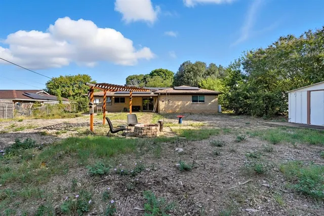a view of a house with backyard porch and sitting area