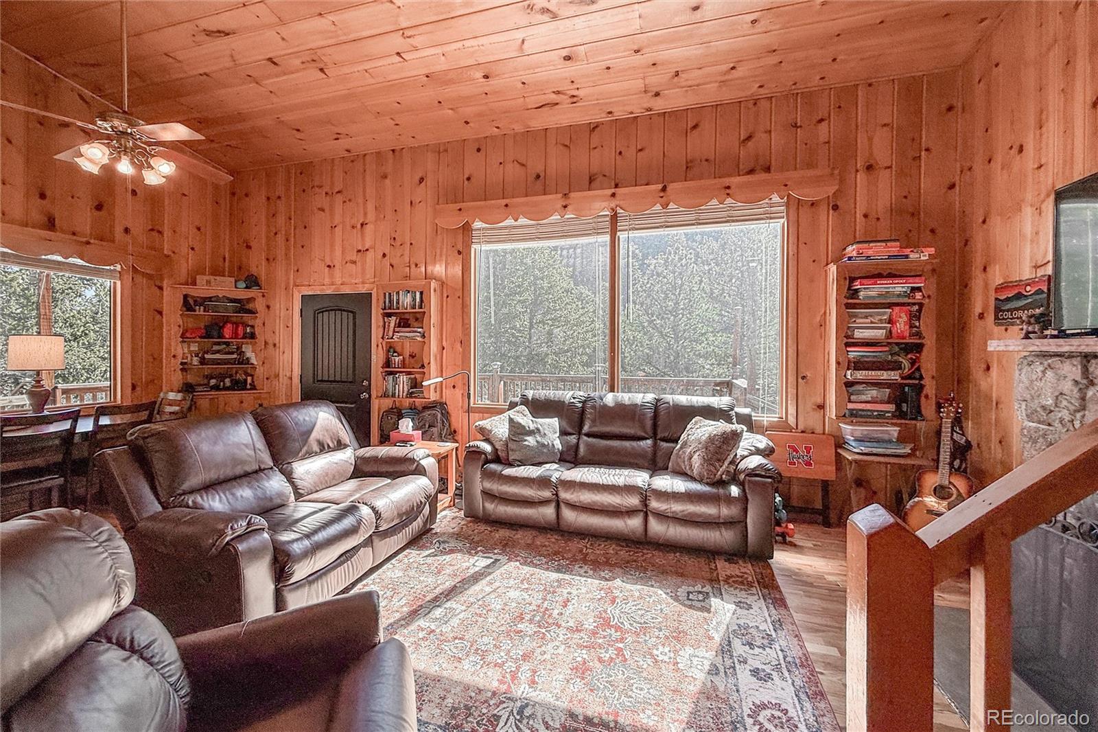 3148 Riverside Drive Lyons, CO 80540 - Photo 17 of 41 a living room with furniture a large window and a rug