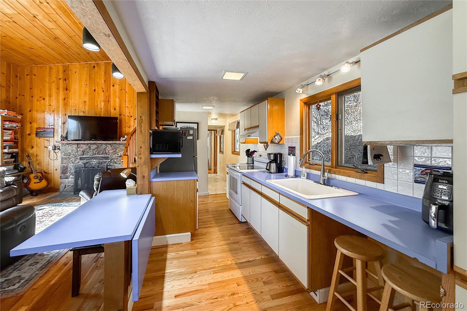 3148 Riverside Drive Lyons, CO 80540 - Photo 19 of 41 a large kitchen with a table chairs and flat screen tv