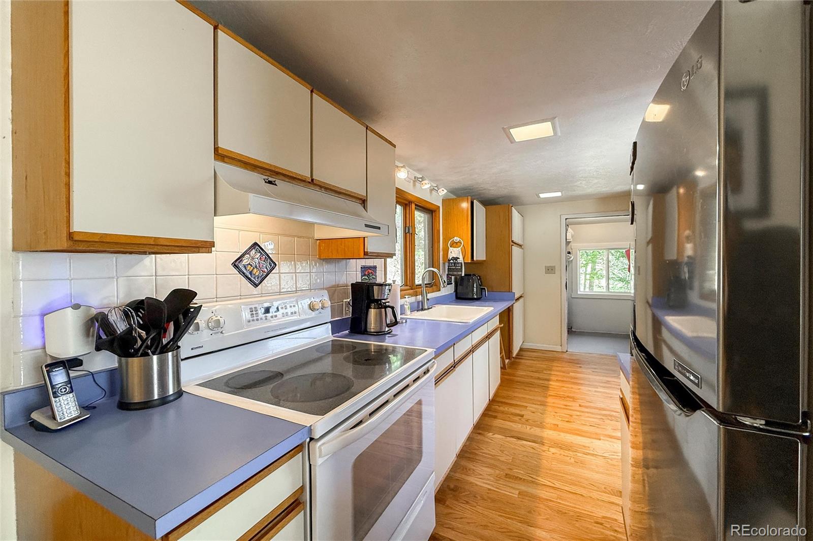 3148 Riverside Drive Lyons, CO 80540 - Photo 20 of 41 a kitchen with kitchen island a sink appliances and cabinets