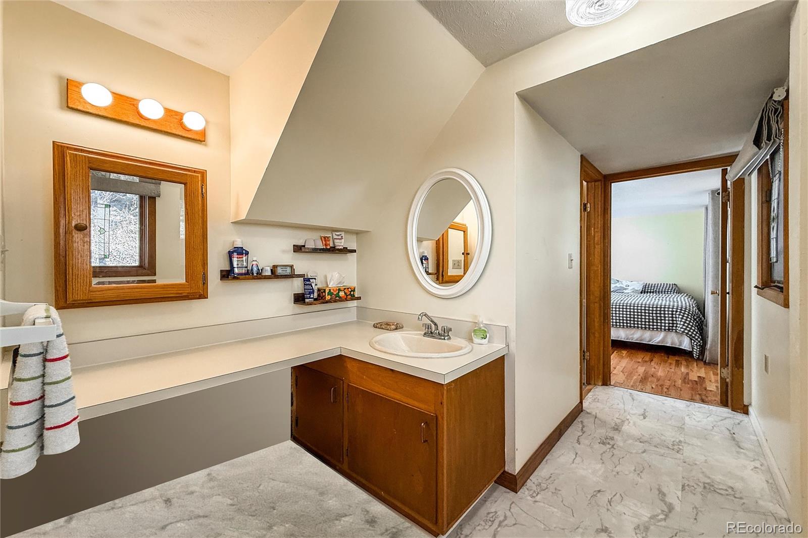3148 Riverside Drive Lyons, CO 80540 - Photo 31 of 41 a en suite bathroom with a sink and a mirror
