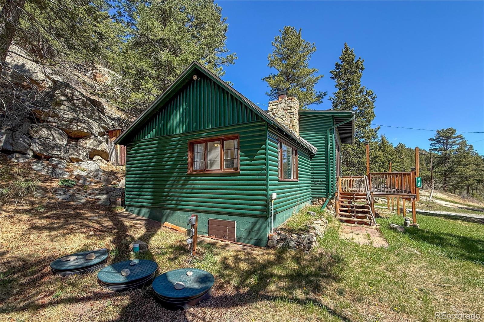 3148 Riverside Drive Lyons, CO 80540 - Photo 36 of 41 a front view of a house with a yard