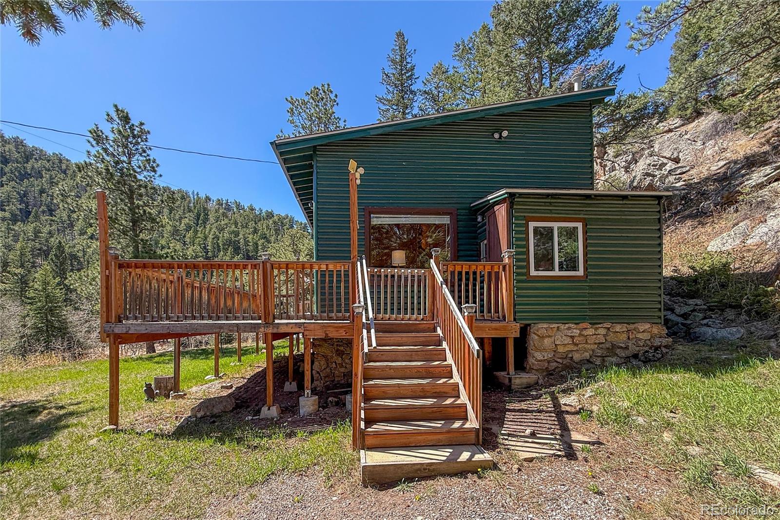 3148 Riverside Drive Lyons, CO 80540 - Photo 38 of 41 a view of a house with backyard and wooden deck