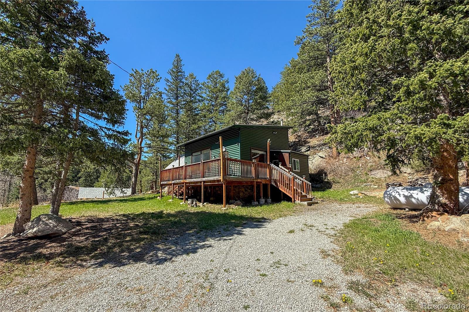 3148 Riverside Drive Lyons, CO 80540 - Photo 5 of 41 a front view of a house with a yard