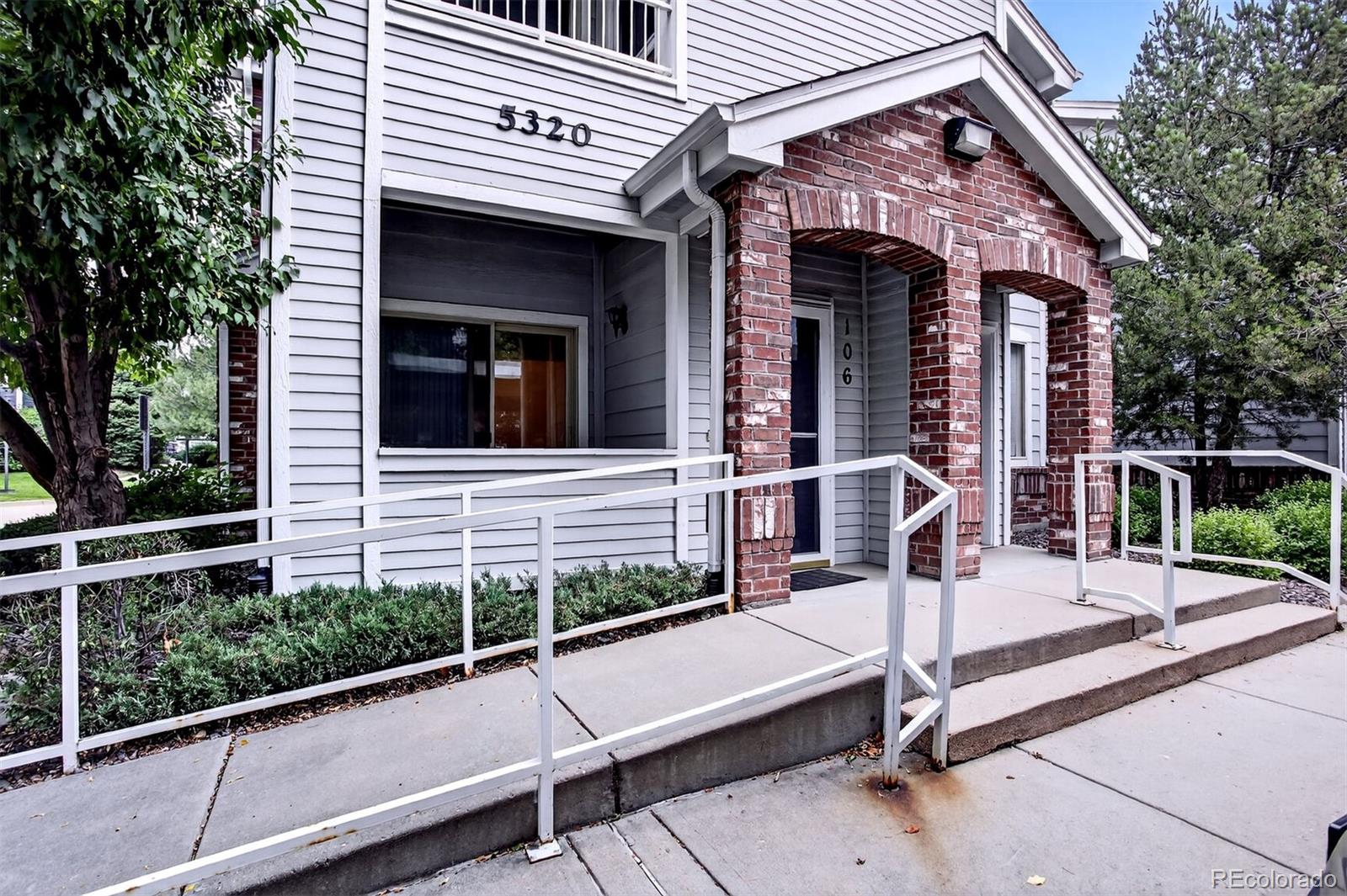 a view of a house with a wooden fence