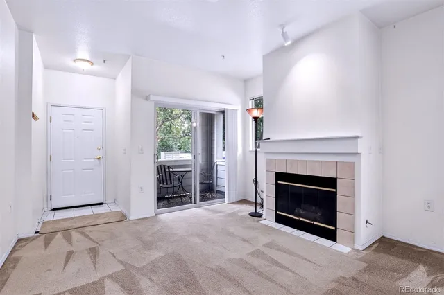 a view of a livingroom with a fireplace and window