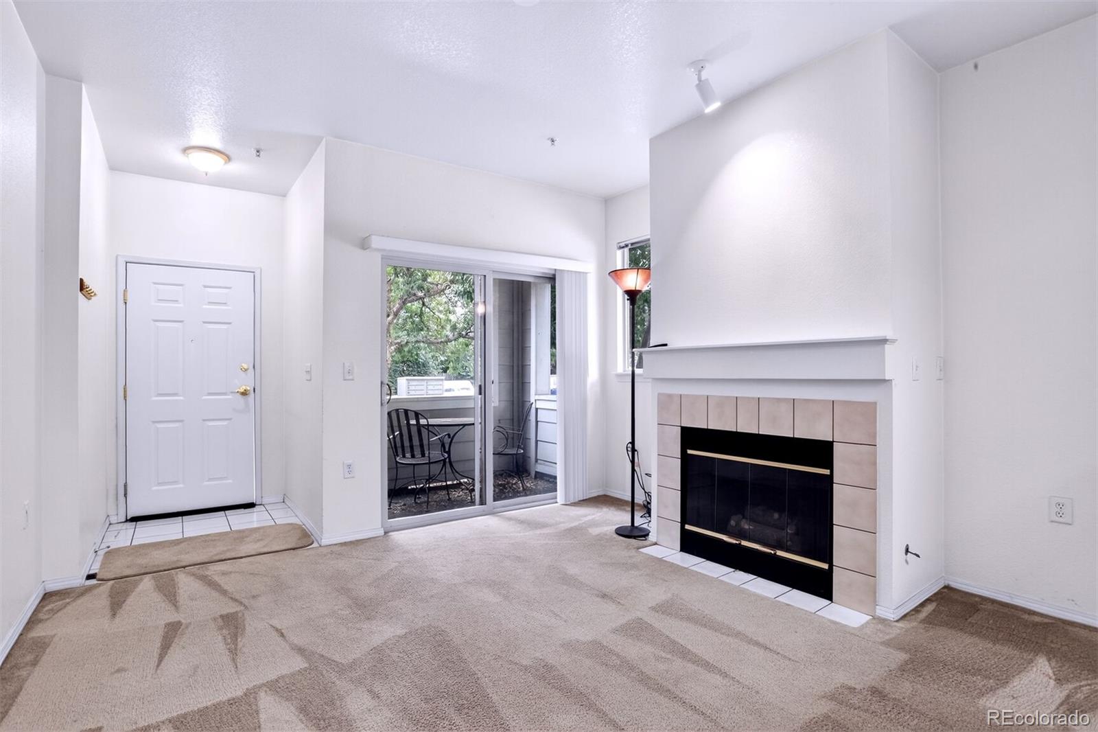 5320 Allison Street, Unit 106 Arvada, CO 80002 - Photo 3 of 15 a view of a livingroom with a fireplace and window