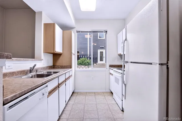 a kitchen with a sink stove and refrigerator