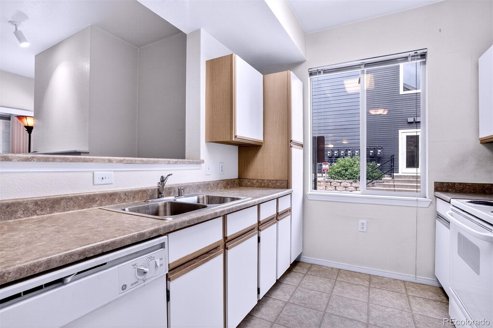 5320 Allison Street, Unit 106 Arvada, CO 80002 - Photo 7 of 15 a kitchen with a sink and cabinets