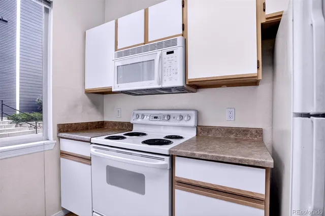 a kitchen with granite countertop cabinets stainless steel appliances and a sink