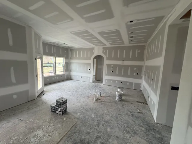 an empty room with fireplace and windows