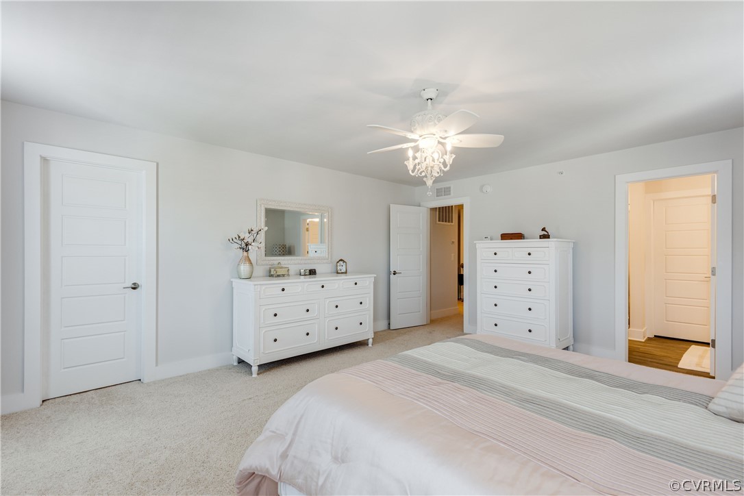 4332 Saunders Station Loop, Unit B Henrico, VA 23233 - Photo 27 of 42 a spacious bedroom with a bed and a chandelier