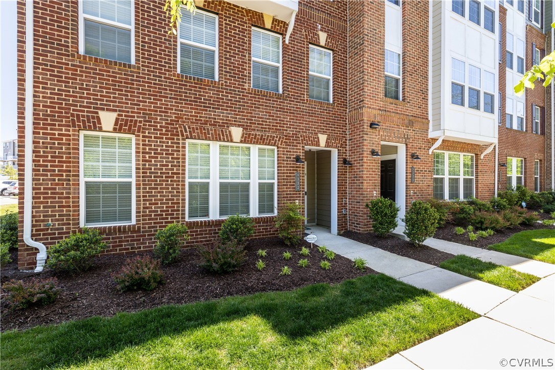 4332 Saunders Station Loop, Unit B Henrico, VA 23233 - Photo 4 of 42 a view of a brick house with many windows plants and large trees