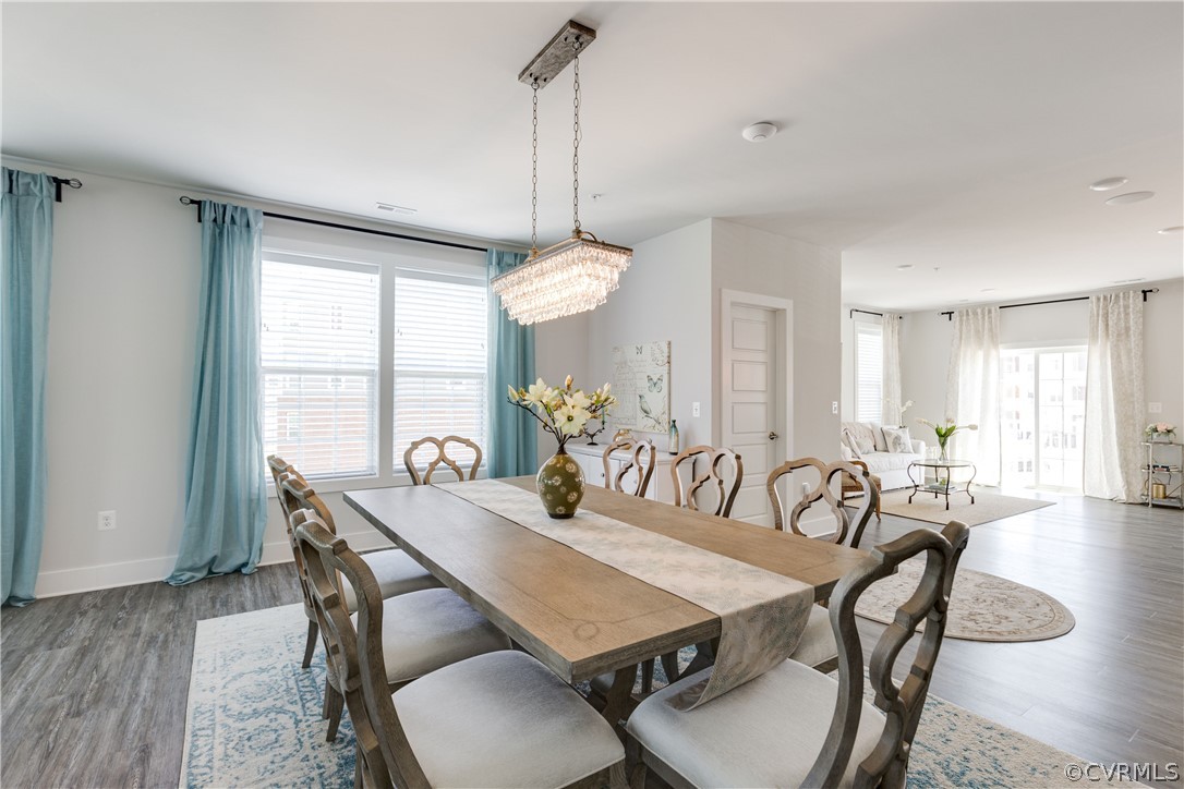 4332 Saunders Station Loop, Unit B Henrico, VA 23233 - Photo 9 of 42 a view of a dining room and livingroom with furniture wooden floor a chandelier