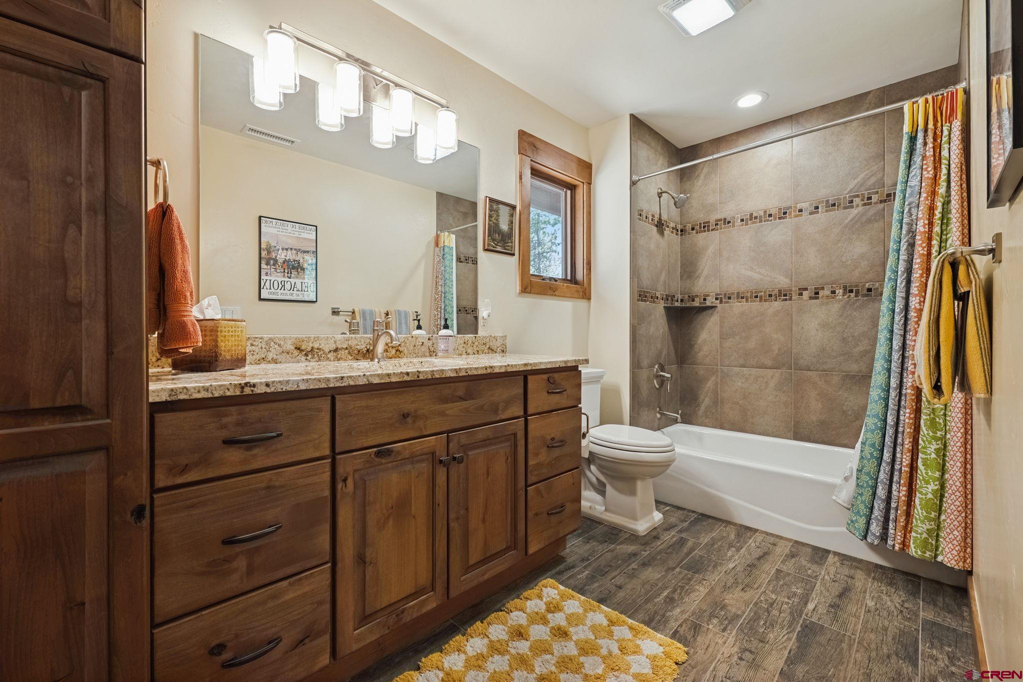 449 Monarch Crest Trail Durango, CO 81301 - Photo 37 of 45 a bathroom with a double vanity sink toilet mirror and bathtub