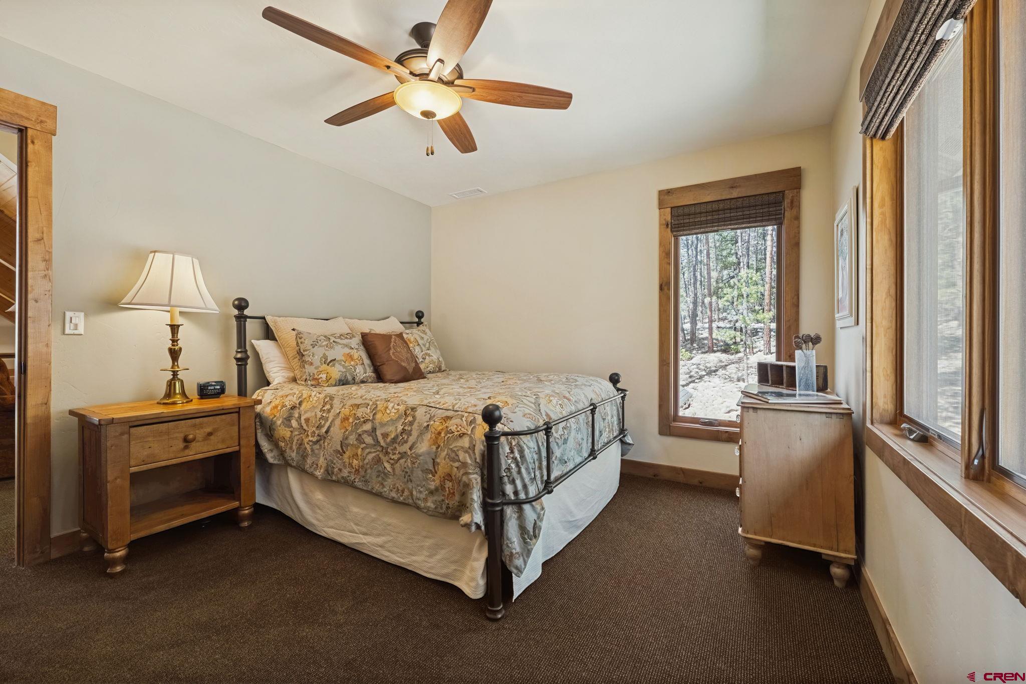 449 Monarch Crest Trail Durango, CO 81301 - Photo 38 of 45 a bed room with a bed and a chandelier