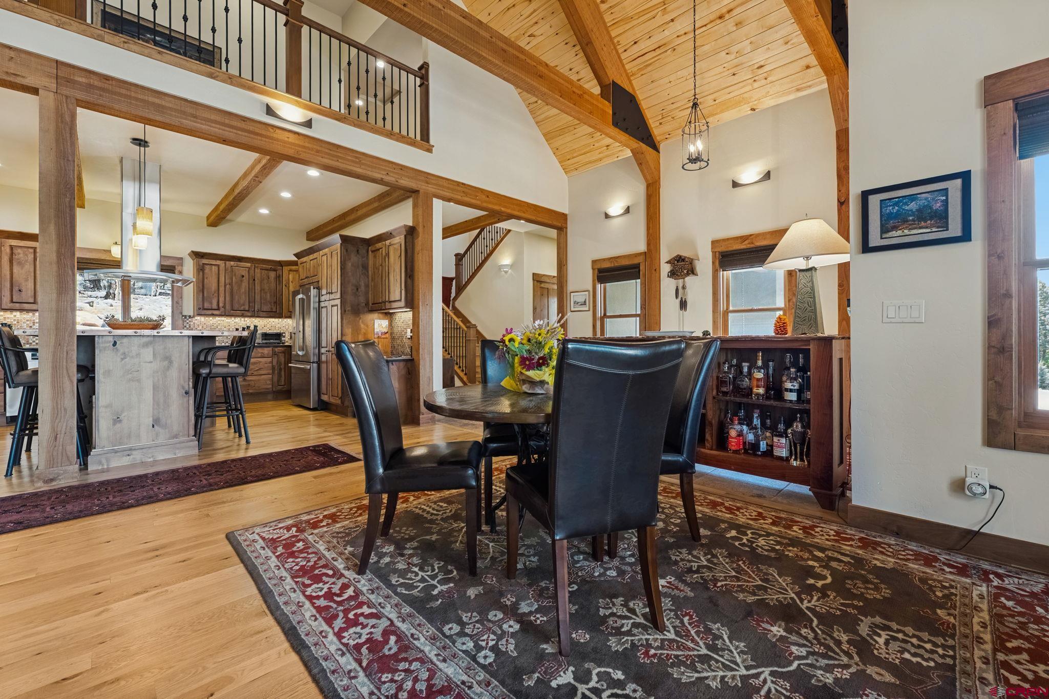 449 Monarch Crest Trail Durango, CO 81301 - Photo 8 of 45 a view of a dining room with furniture wooden floor and a rug