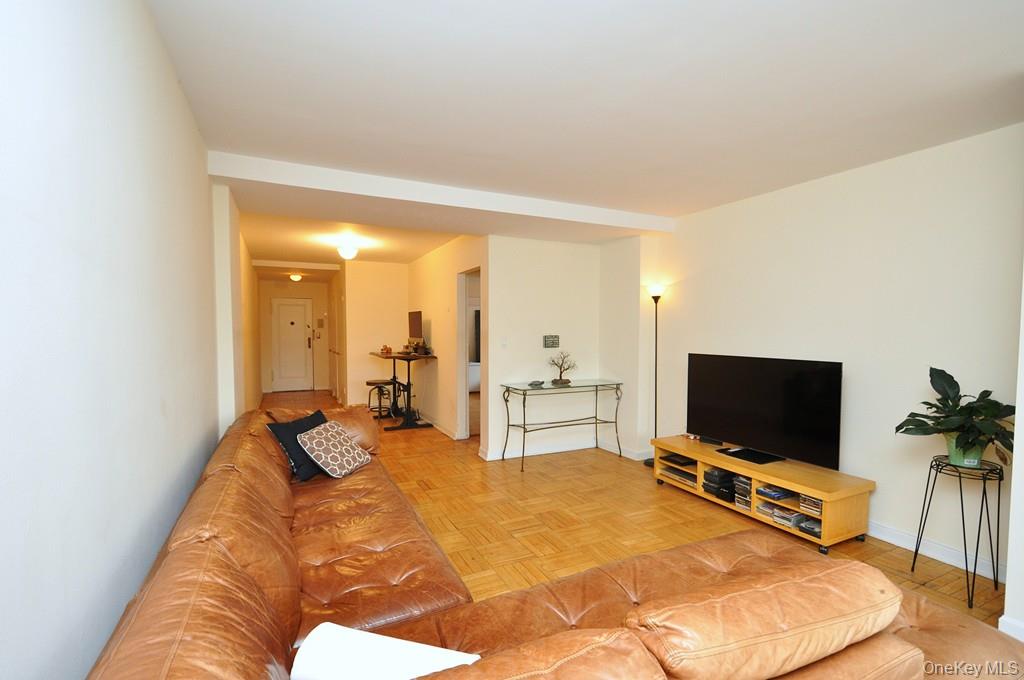 235 Garth Road, Unit D5E Scarsdale, NY 10583 - Photo 16 of 49 The sunny oversized living room has southern exposures, parquet floors opens to the foyer and entry hallway and has French doors separating the Den/Home Office/Guest Room The living room is over 21 feet long.