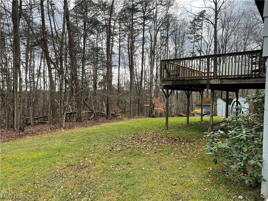 6950 Walker Road Walker, WV 26180 - Photo 19 of 22 View of backyard with a deck and a storage shed
