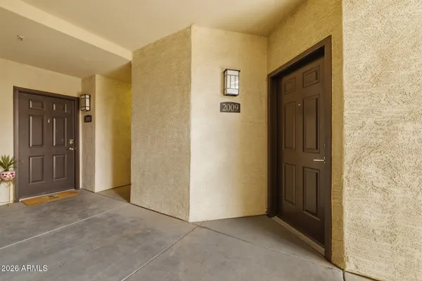 a view of a hallway with wooden cabinets