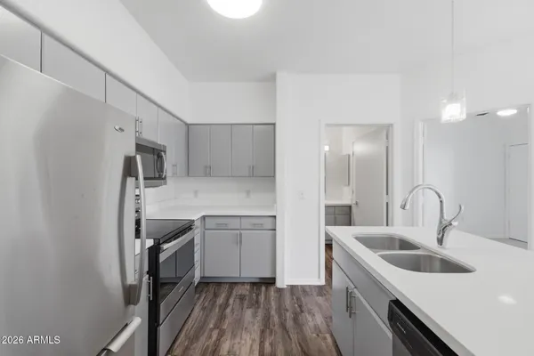 a kitchen with stainless steel appliances granite countertop a sink stove and refrigerator