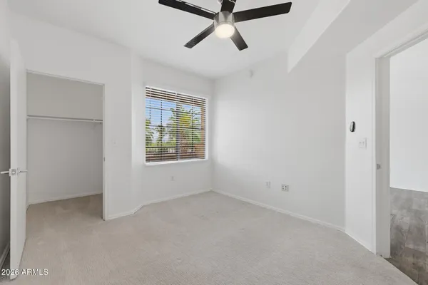 a view of a livingroom with a ceiling fan and window