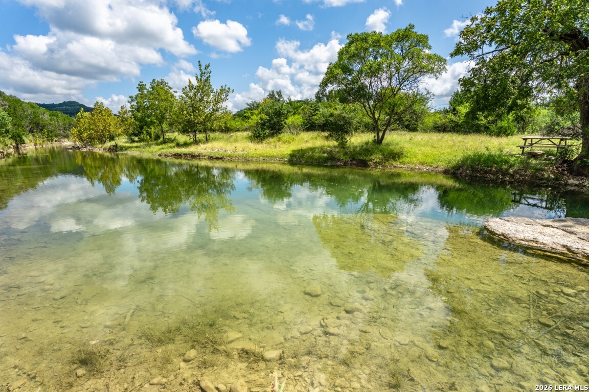 5013 North Little Creek Road Utopia, TX 78884 - Photo 1 of 39 a view of a lake with a yard