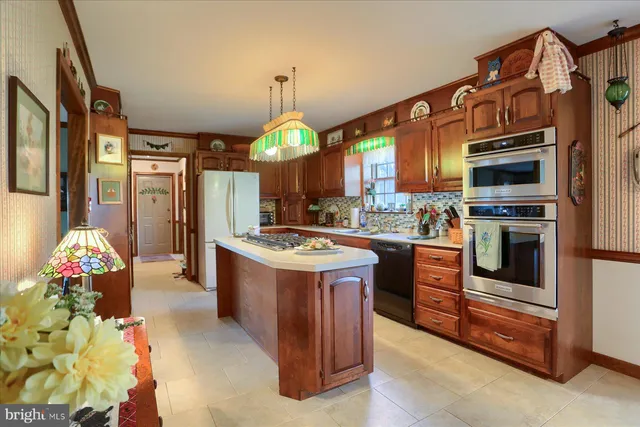 a kitchen with granite countertop a stove and a sink