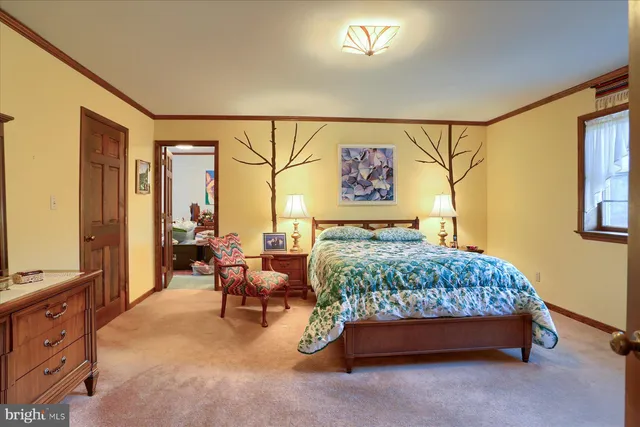 a bedroom with a bed and a dresser with mirror