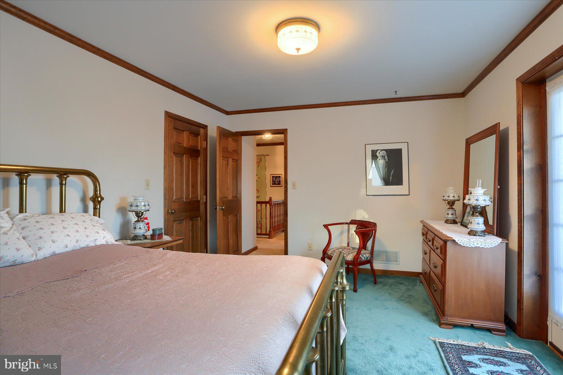 1065 Kuhn Road Boiling Springs, PA 17007 - Photo 26 of 49 a bedroom with a bed next to a window with pc on the wall