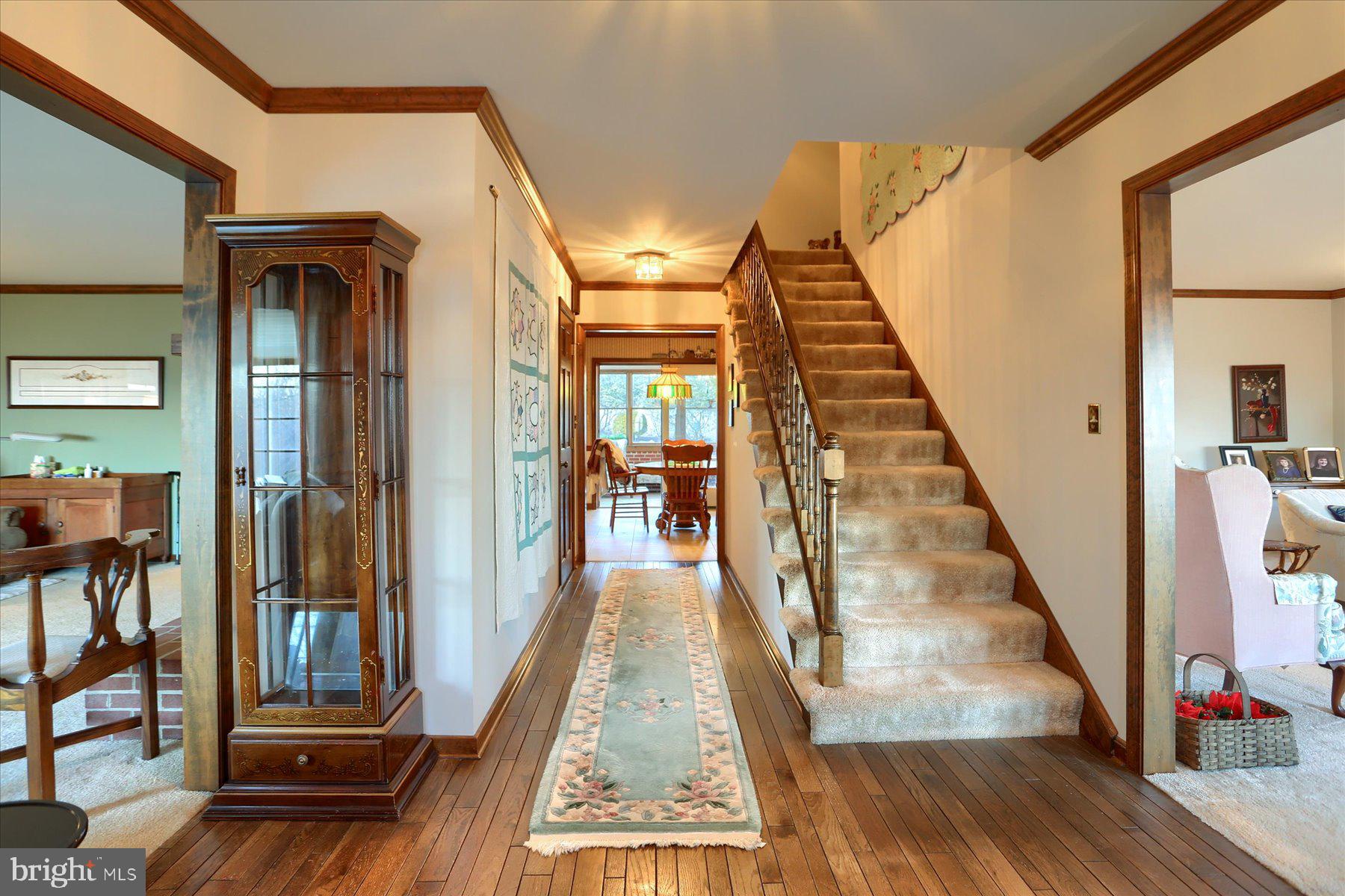 1065 Kuhn Road Boiling Springs, PA 17007 - Photo 8 of 49 a view of a hallway with wooden floor and staircase