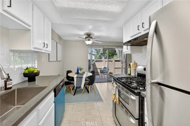 a kitchen with stainless steel appliances a sink a stove and refrigerator