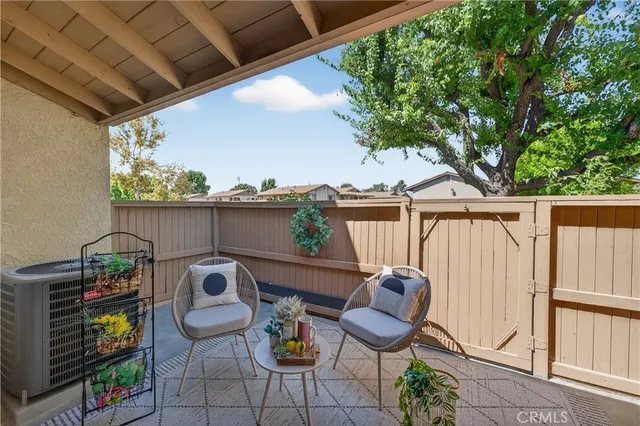 a view of a chairs and table in patio