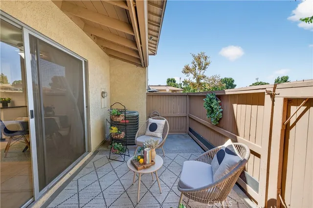 a view of a couches and dinning table in patio