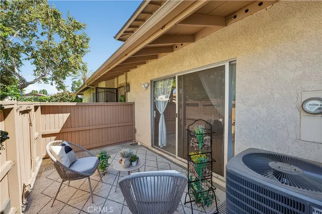 a view of a chair and tables back yard of the house