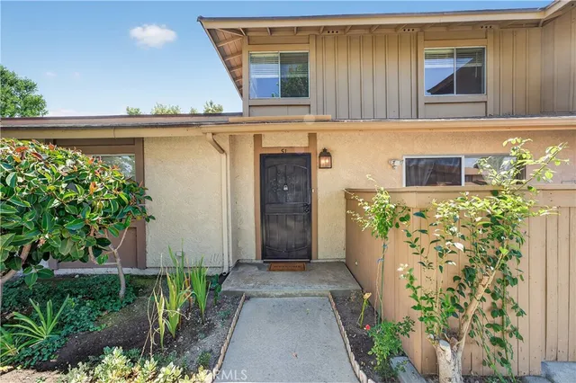 front view of a house with a window and flowers