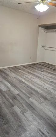 a view of a room with wooden floor