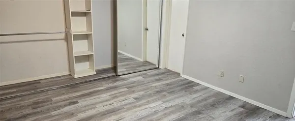 a view of a small space with wooden floor