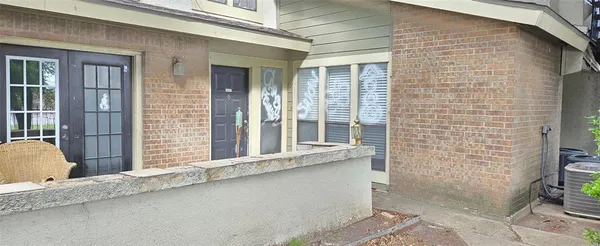 a view of a brick house with a large window